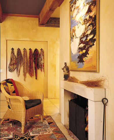 This massive cast-earth, wood-burning fireplace in the dining area provides heat to be held in 18-inch-thick walls and released during cool California nights. Opposite, more warmth comes from radiant-heat flooring in the living area.